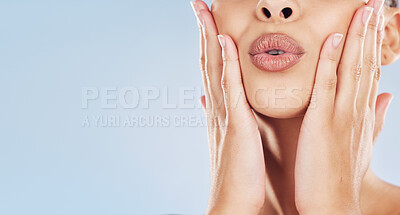 Buy stock photo Woman, lips and closeup in studio for skincare, beauty and cosmetics with healthy skin, touch and face. Model, mouth and mockup space on blue background for dermatology, aesthetic and facial glow