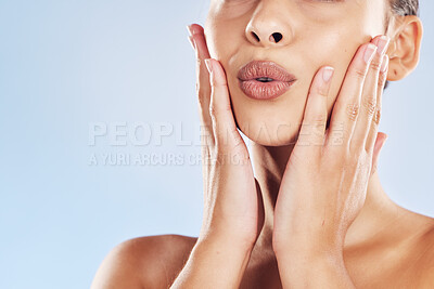 Buy stock photo Woman, mouth and touch in studio for skincare, beauty and cosmetics with healthy skin, glow and closeup. Model, lips and hands on blue background for dermatology, aesthetic and facial transformation