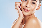 Closeup face beautiful young mixed race woman. An attractive female posing in studio isolated against a blue background. A skincare regime that keeps your skin soft, smooth, glowing and healthy