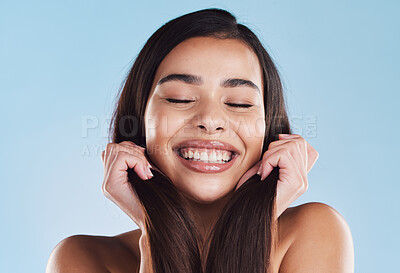 Buy stock photo Woman, hair care and holding for results in studio with thinking, growth and idea by blue background. Model, girl and person with hairstyle, reflection and excited with beauty, change and wellness