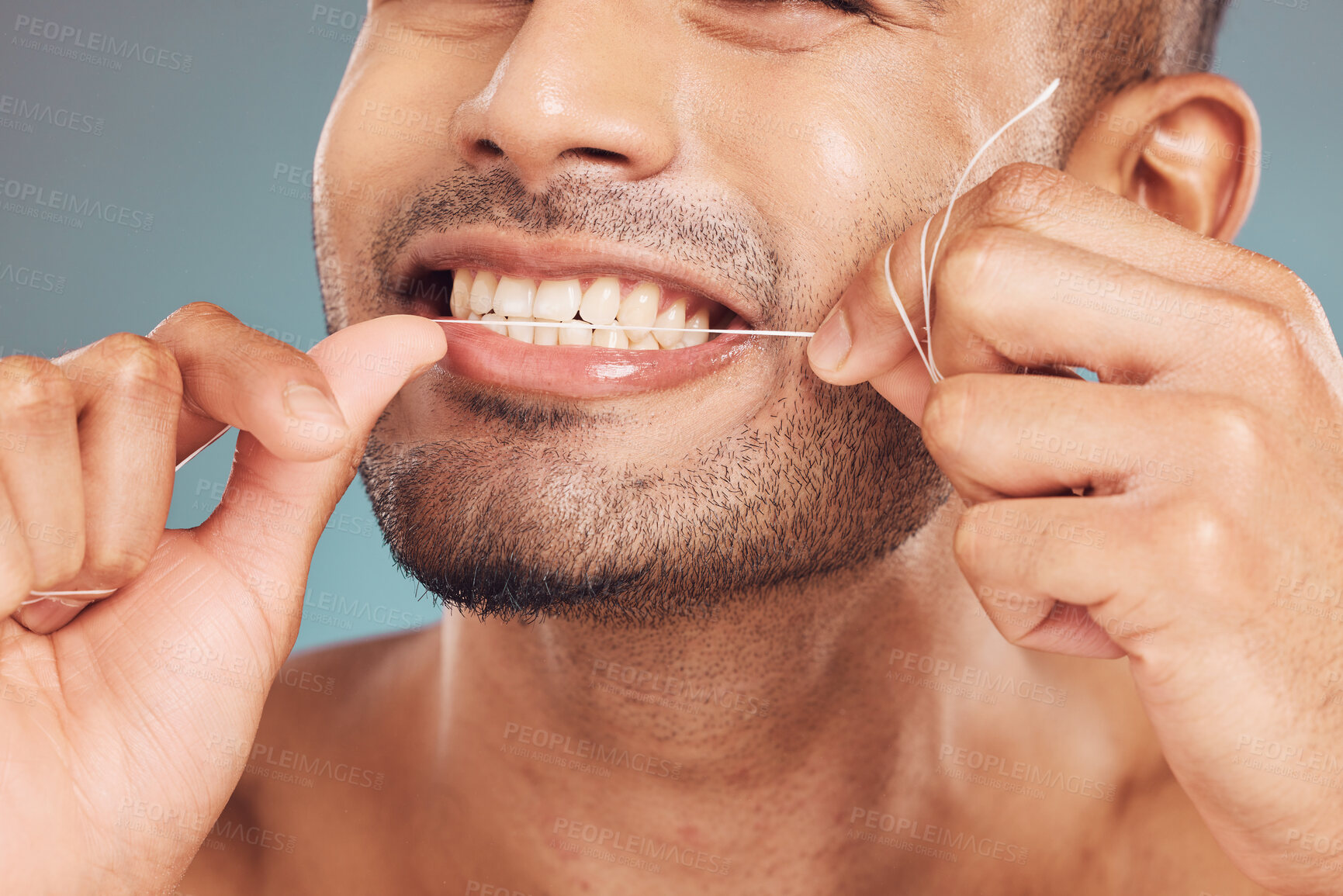 Buy stock photo Studio, mouth and man with floss for dental, gum health and wellness with cleaning for fresh breath. Male model, product and string by gray background for teeth care, gingivitis and oral hygiene