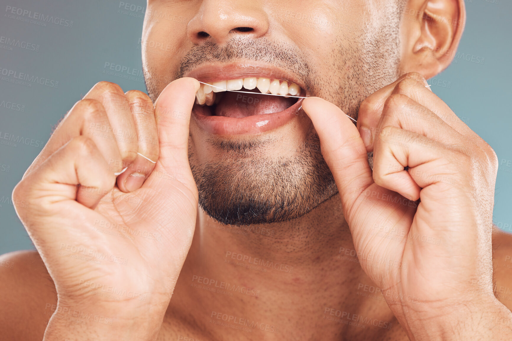 Buy stock photo Man, closeup and floss for teeth, dental and cleaning mouth on studio background as hygiene or grooming. Male person, dentistry and oral care, healthy tooth or fresh breath with gingivitis prevention