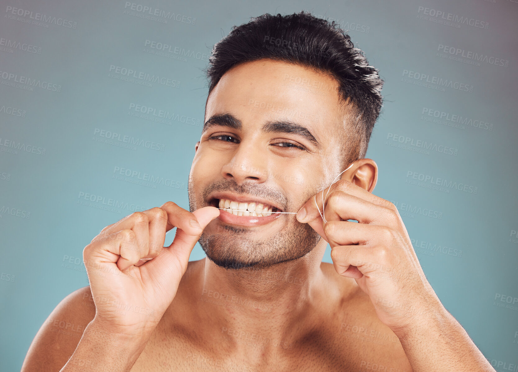 Buy stock photo Studio, portrait and happy man with floss for dental, gum health and wellness with cleaning for fresh breath. Male model, hands or string by gray background for teeth care, gingivitis or oral hygiene