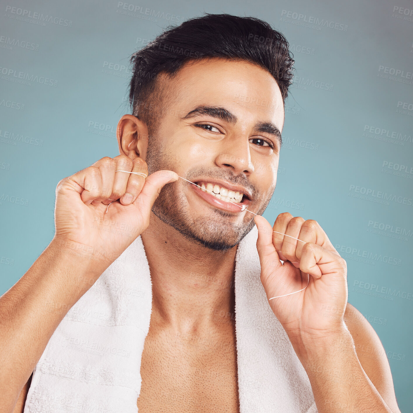 Buy stock photo Studio, portrait and man with dental floss for hygiene, gum health and wellness with cleaning for fresh breath. Male model, teeth and string by blue background for mouth, gingivitis and oral care