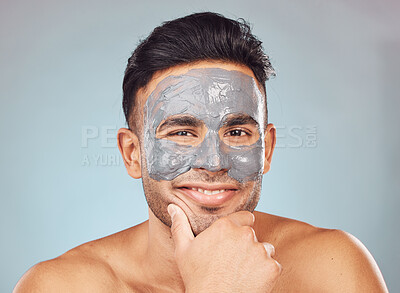 Buy stock photo Skincare, portrait and happy man with mask, charcoal face treatment and product for skin glow on blue background. Cosmetics, dermatology and male person with clay facial for morning routine in studio