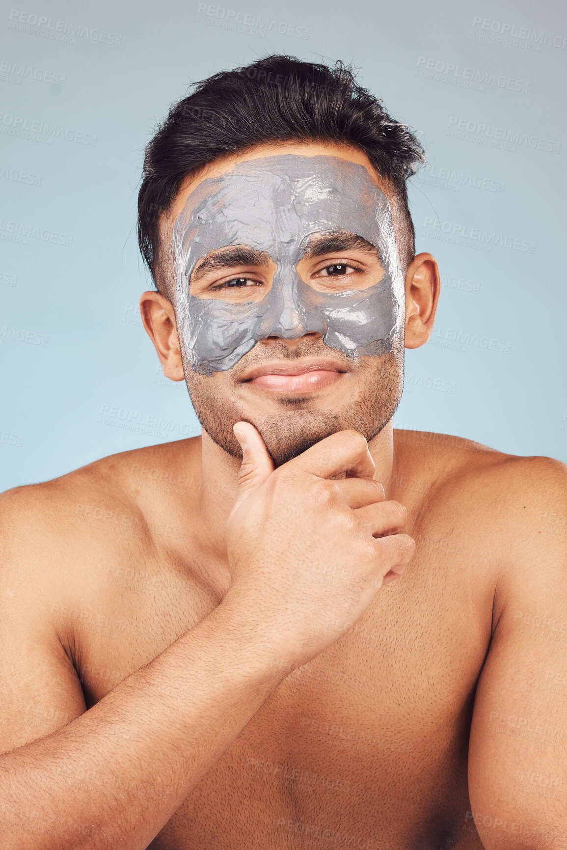 Buy stock photo Skincare, portrait and man with mask, mud facial treatment and clay product for skin glow on blue background. Cosmetics, dermatology and male person with charcoal detox for morning routine in studio