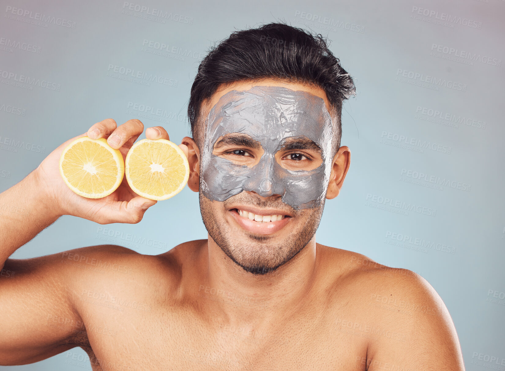 Buy stock photo Man, lemons and face mask for skincare, dermatology and organic cleaning on studio background with smile. Male person, portrait and charcoal facial for skin texture or hydration with natural cosmetic