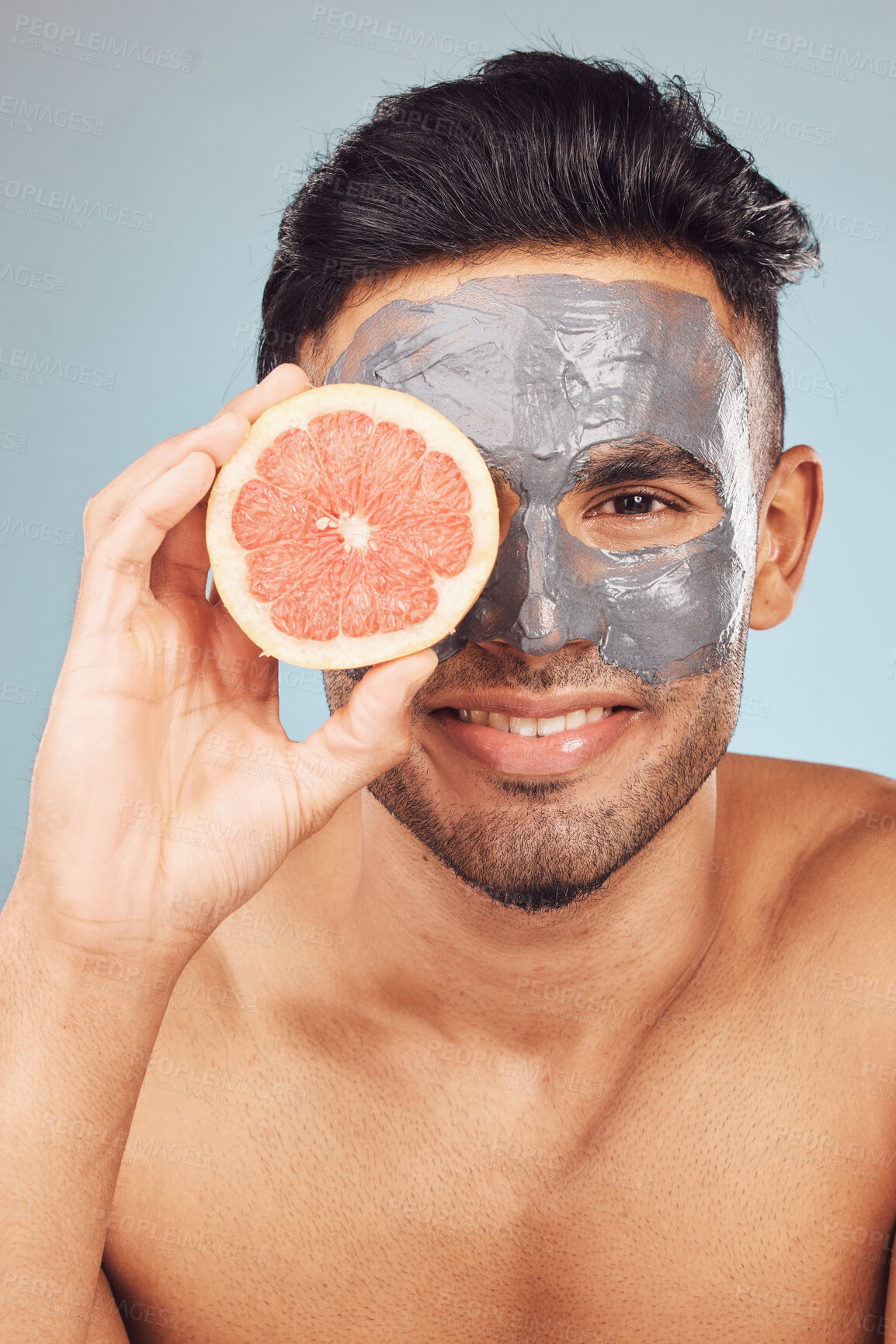 Buy stock photo Man, grapefruit and smile for skincare, face mask and cleaning on studio background with portrait. Male person, dermatology and organic charcoal facial for skin and hydration with natural cosmetic