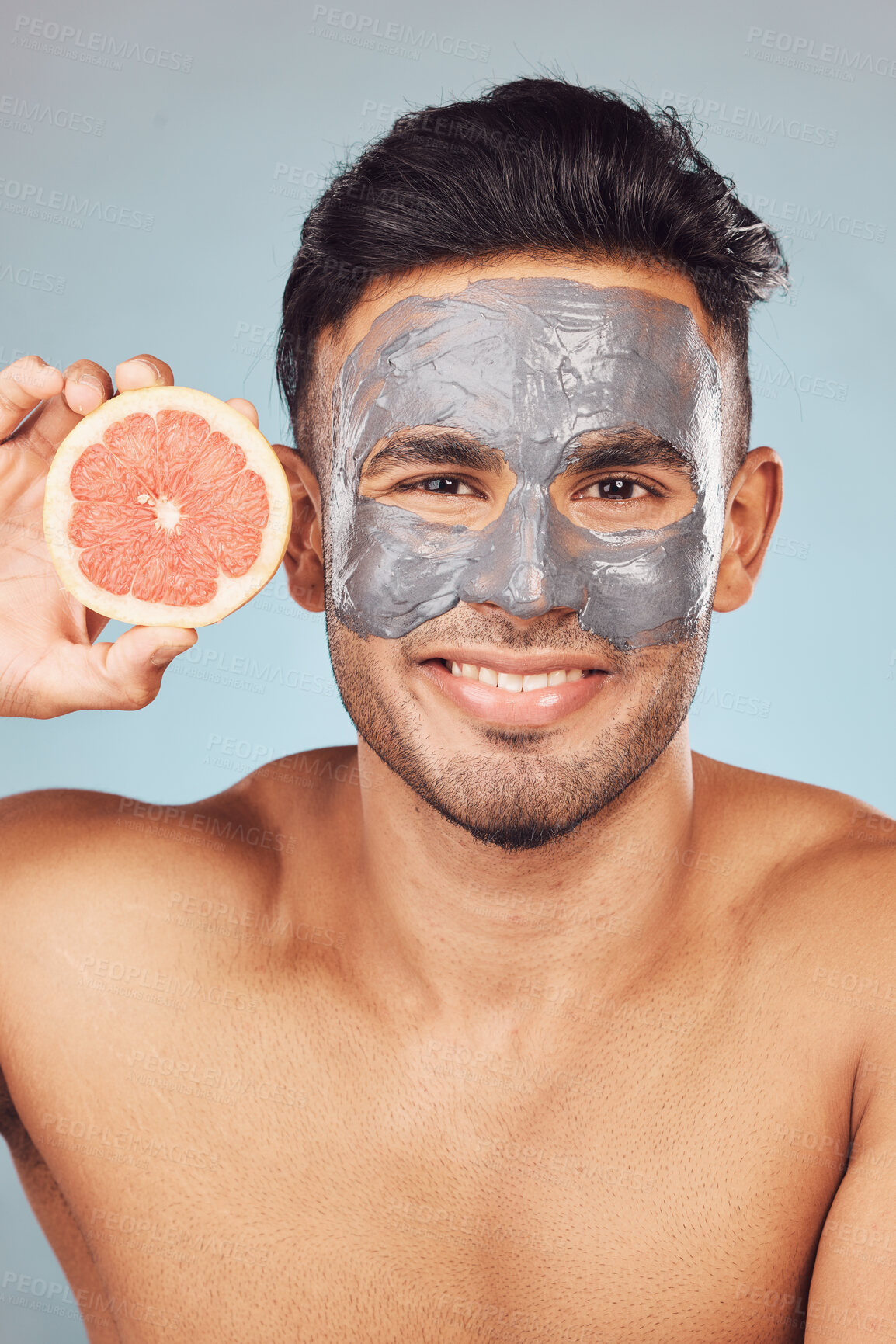 Buy stock photo Man, grapefruit and portrait for skincare, face mask and organic cleaning on studio background with smile. Male person, dermatology and charcoal facial for skin and hydration with natural cosmetic