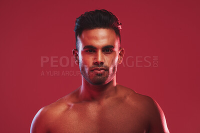 Buy stock photo Man, shirtless and fitness in studio portrait with confidence, pride and change by red background. Person, model and topless with bodybuilding, health and wellness with muscle growth in Colombia