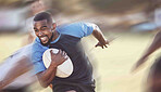 African american rugby player running away from an opponent while attempting to score a try during a rugby match outside on a field. Black man making a play to try and win the game for his team