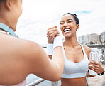 Handshake, women and fitness training winner achievement for running competition in city street. Happy girls, smiling and support after successful sports goal wellness workout together outdoors