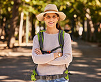 Portrait, hiking and woman in hat arms crossed on holiday, vacation or trip. Travel, freedom and female from Canada on hike, explore or adventure outdoors in nature, having fun or spending time alone