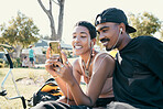 Couple, phone and video on social media in park, app or internet with smile, laugh or happiness. Black woman, man and smartphone for meme, social network or video call on web, online or communication