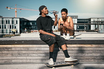 Buy stock photo Skateboard, drinking water and friends with a black man and woman skater outdoor in a city for fun or recreation together. Couple, skating and summer with a male and female in an urban town to skate