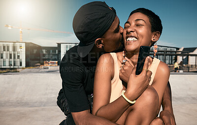 Buy stock photo Couple, hug and kiss while bonding in city with phone for social media and internet search for fun Brazilian activity. Smile, happy and love man and black woman with 5g mobile technology and fashion