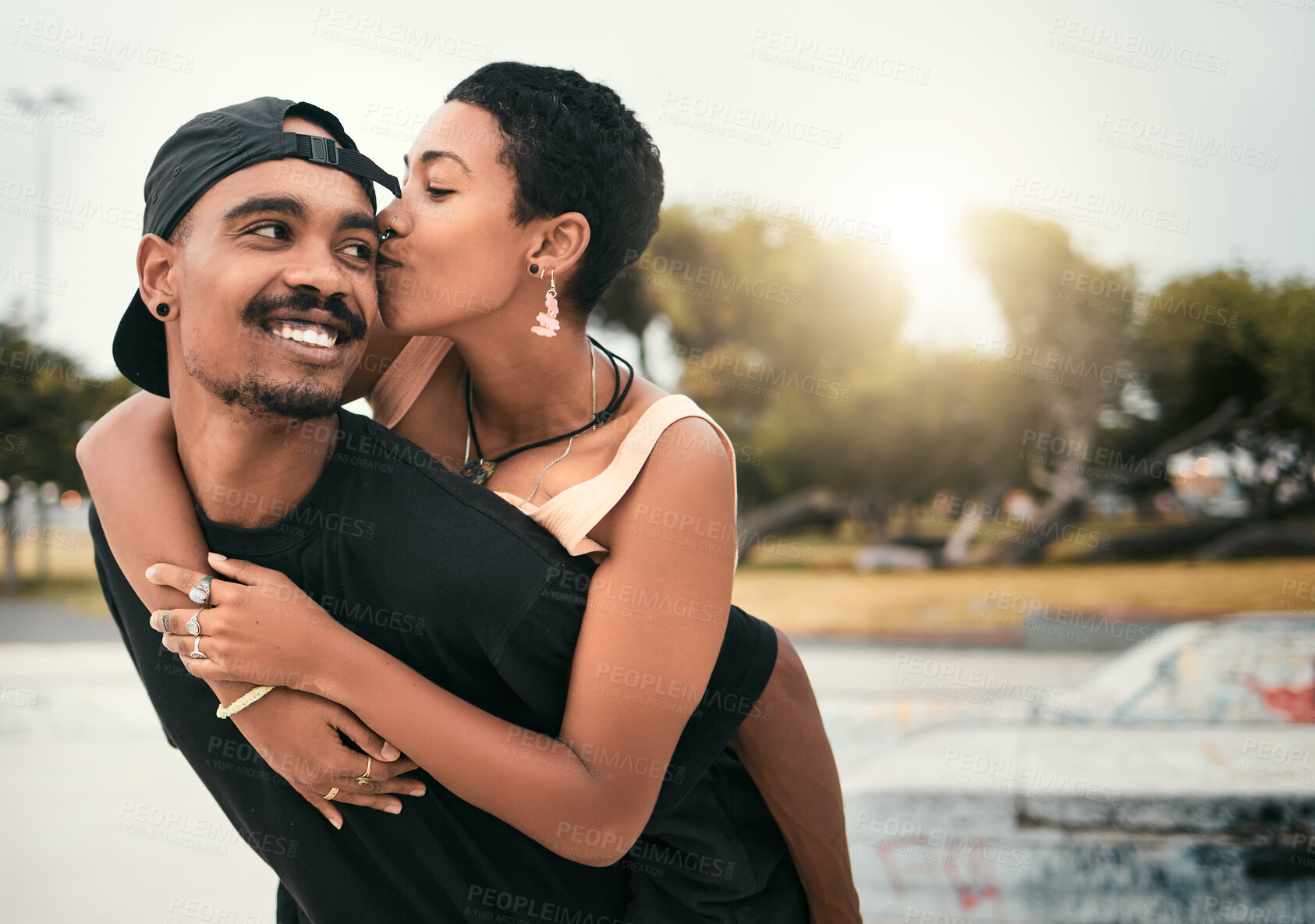 Buy stock photo Black couple, hug and cheek kiss in city, affection or bonding together with smile. Love, romance and happy man and woman enjoying quality time together outdoors in urban town, having fun and kissing