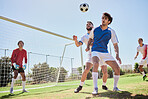 Soccer, sports and team playing game on an outdoor field for exercise, training and workout. Teamwork, football and healthy athletes practicing with ball on a grass pitch for match, fitness and skill