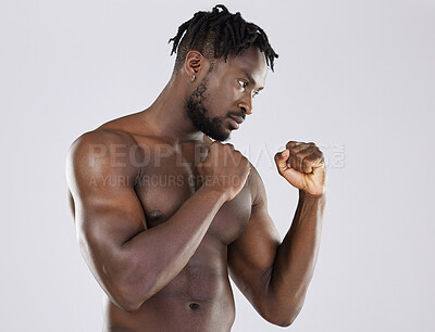 Buy stock photo Muscular, fight and black man with focus, training and determination with guy against grey studio background. Muscles, African American male fighter or athlete practice, power or endurance for energy