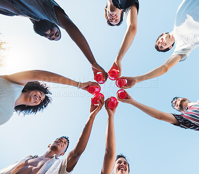 Buy stock photo Cheers, sky and alcohol with a group of friends making a toast together at a party from below. Beer, freedom and drink with a man and woman friend group toasting outdoor during summer celebration