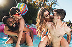 Summer, piggyback and couple of friends in pool for  vacation fun and togetherness in the sunshine. Gen z, youth and young people bond, laugh and smile in swimsuit on holiday resort break.

