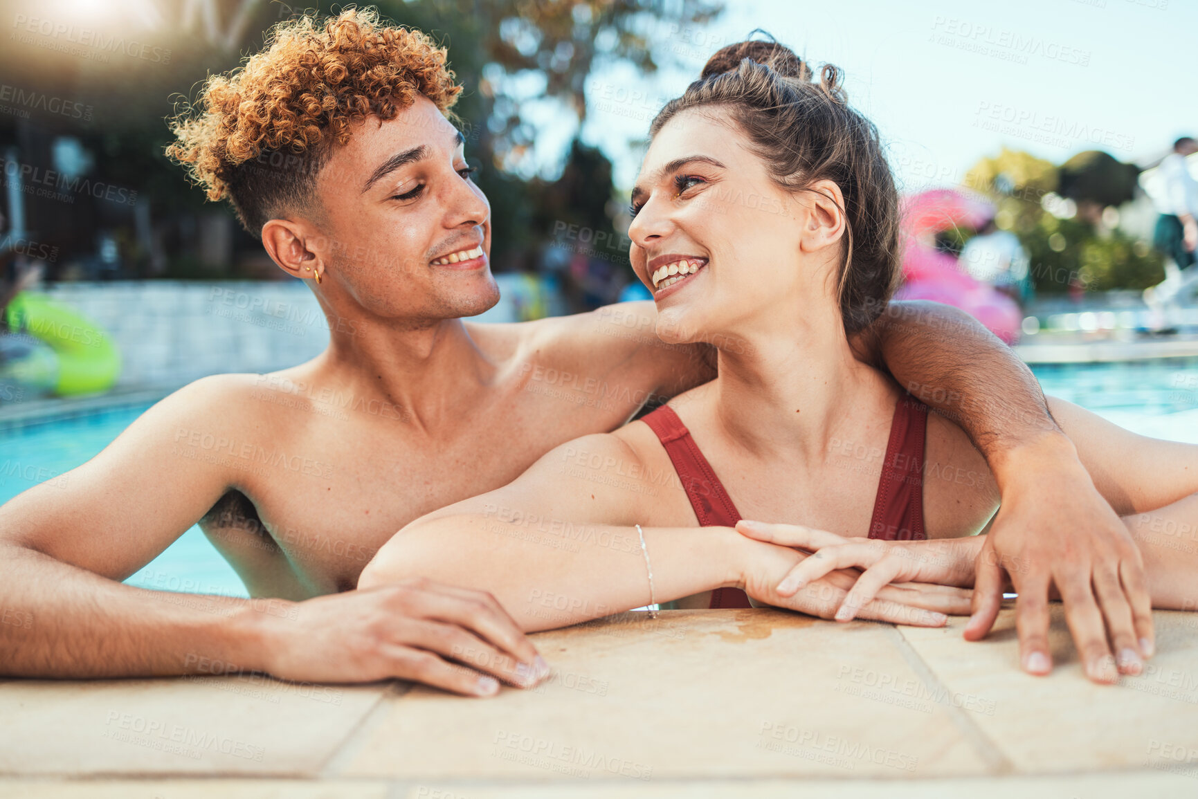 Buy stock photo Party, swimming and diversity with a couple of friends in the pool outdoor together during summer. Love, water and swim with a young man and woman swimmer enjoying a birthday or celebration event