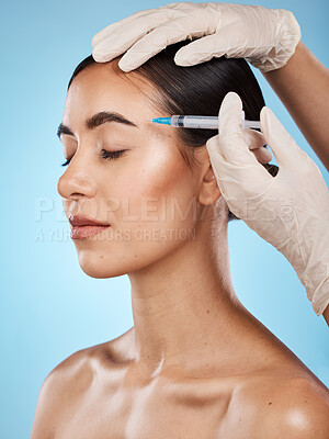 Buy stock photo Skincare, filler and woman in a studio with beautician for face enhancement, cosmetic or plastic surgery treatment. Beauty, cosmetology and female model getting facial injection by a blue background.