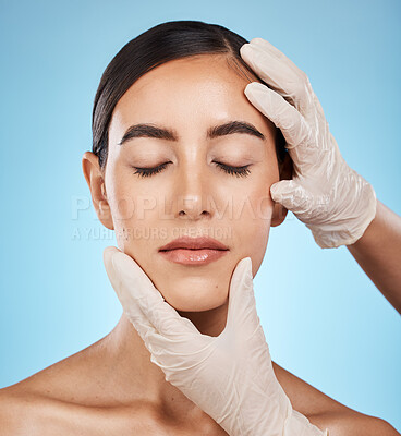 Buy stock photo Cosmetics, plastic surgery and hands check woman face for laser, implant or beauty salon. Skincare consultation, facial or gloves for aesthetic change, liposuction and filler on blue background