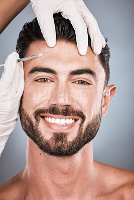 Buy stock photo Needle, man and portrait for skincare, beauty and collagen aesthetic in studio. Derma cosmetics, face injection and male model smile for plastic surgery, transformation or facial filler on background