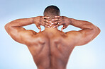 Back, muscle and black man touching neck or head as self love, skincare and isolated in a studio blue background. Health, wellness and strong muscular bodybuilder or model embracing skin