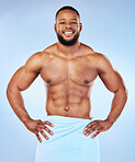 Exercise, shower towel and portrait of a black man with happiness from bodybuilder muscle. Cleaning, skincare and wellness after workout and fitness with isolated, studio and blue background