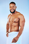 Towel, shower and training portrait of a black man with happiness from bodybuilder abs and arms. Cleaning, skincare and wellness after workout and exercise with isolated, studio and blue background