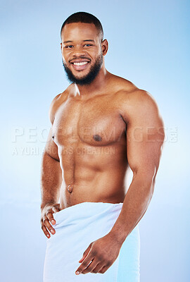 Buy stock photo Black man portrait, muscle body and towel in studio with happiness from bodybuilder fitness. Cleaning, skincare and wellness after sport workout and exercise with isolated, smile and blue background