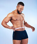 Black man, fitness and body, weightloss and measuring tape  with abs, health and active on blue background, Shirtless male bodybuilder, smile and exercise with diet, healthy and strong in underwear