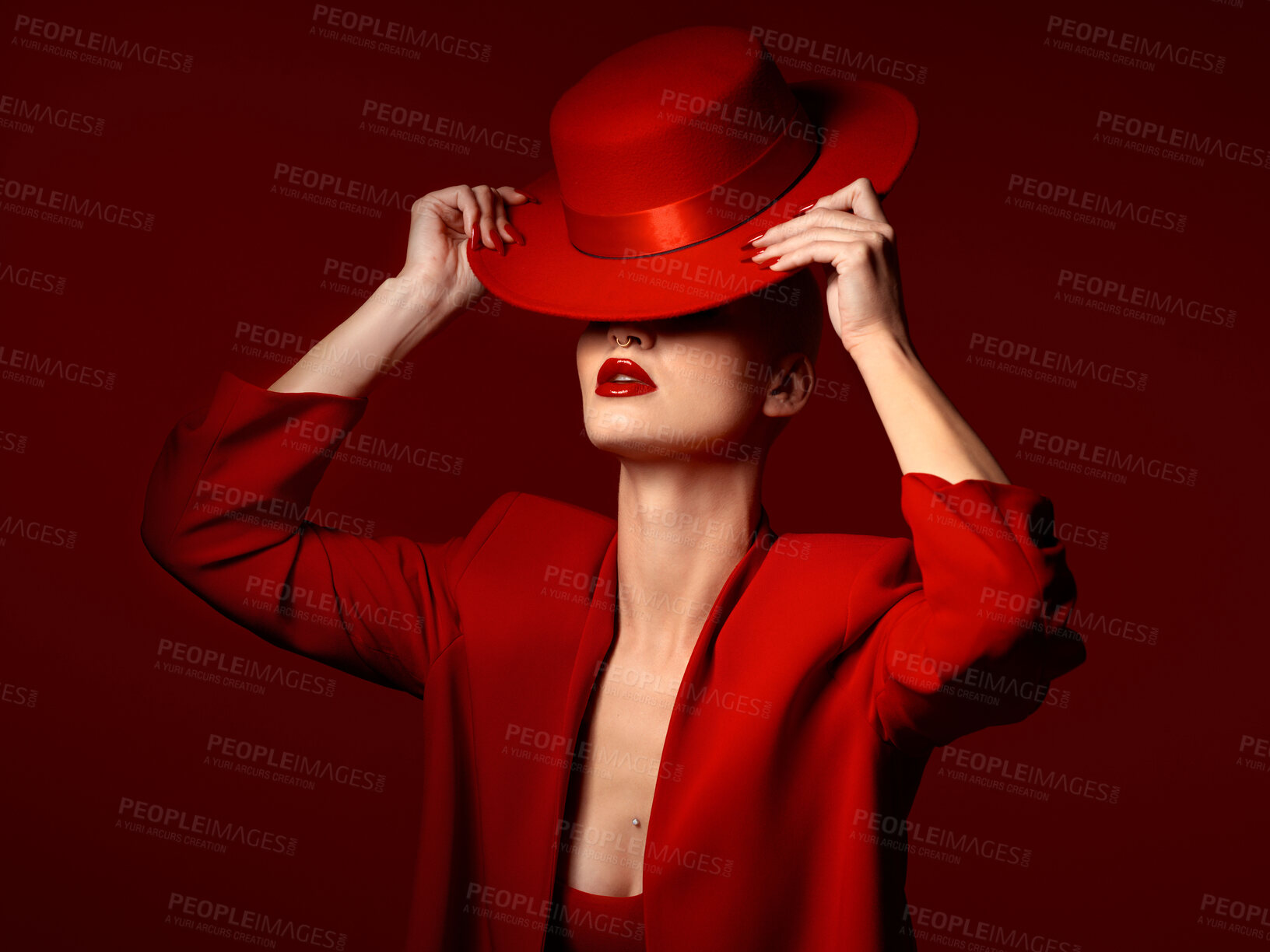 Buy stock photo Woman, red aesthetic and hat in studio with makeup art, thinking and mystery with couture, vision and background. Girl, model and high fashion with suit, mindset and facial paint for cosmetic beauty