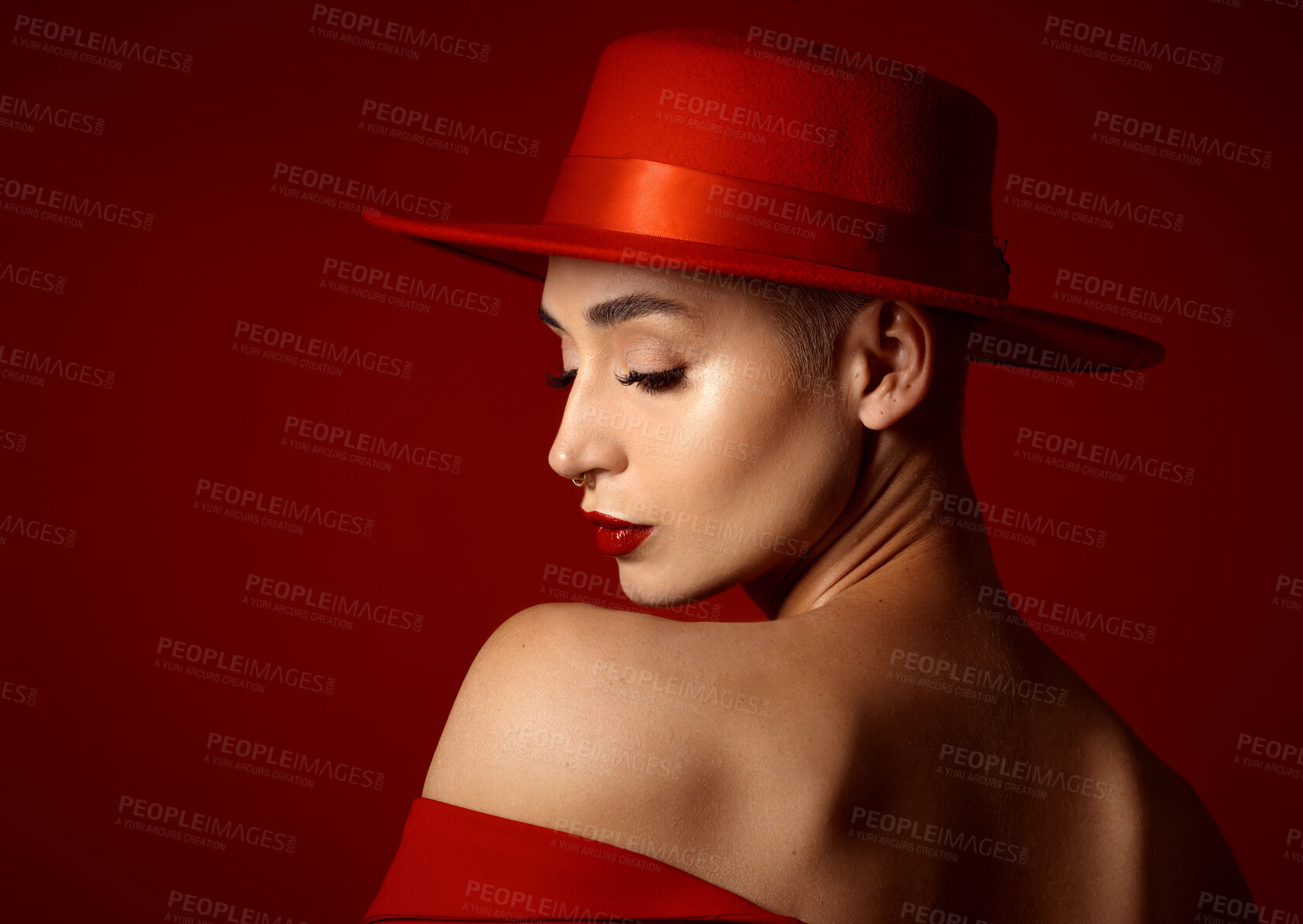 Buy stock photo Back, fashion and a model woman on a red studio background for elegant or trendy style. Aesthetic, face and beauty with a young female person in an edgy, classy or unique outfit for a magazine cover