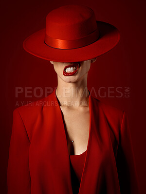 Buy stock photo Woman, red aesthetic and makeup with hat, art and teeth out for couture, emoji and studio background. Girl, model and high fashion with suit, attitude and sexy with beauty, lipstick and cosmetics