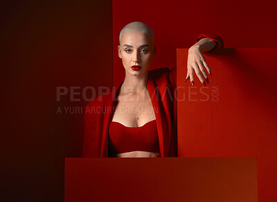 Buy stock photo Portrait, fashion and mockup with a woman on a red background in studio for marketing, advertising or branding. Luxury, aesthetic style or a trendy young female model standing with an empty poster