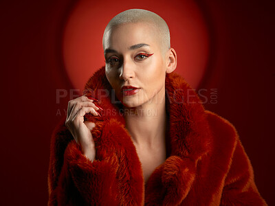 Buy stock photo Fashion, portrait and confident woman in a red coat in studio isolated on a background. Face, makeup and serious model with cosmetics, aesthetic and style, trendy and fur clothes from Switzerland.