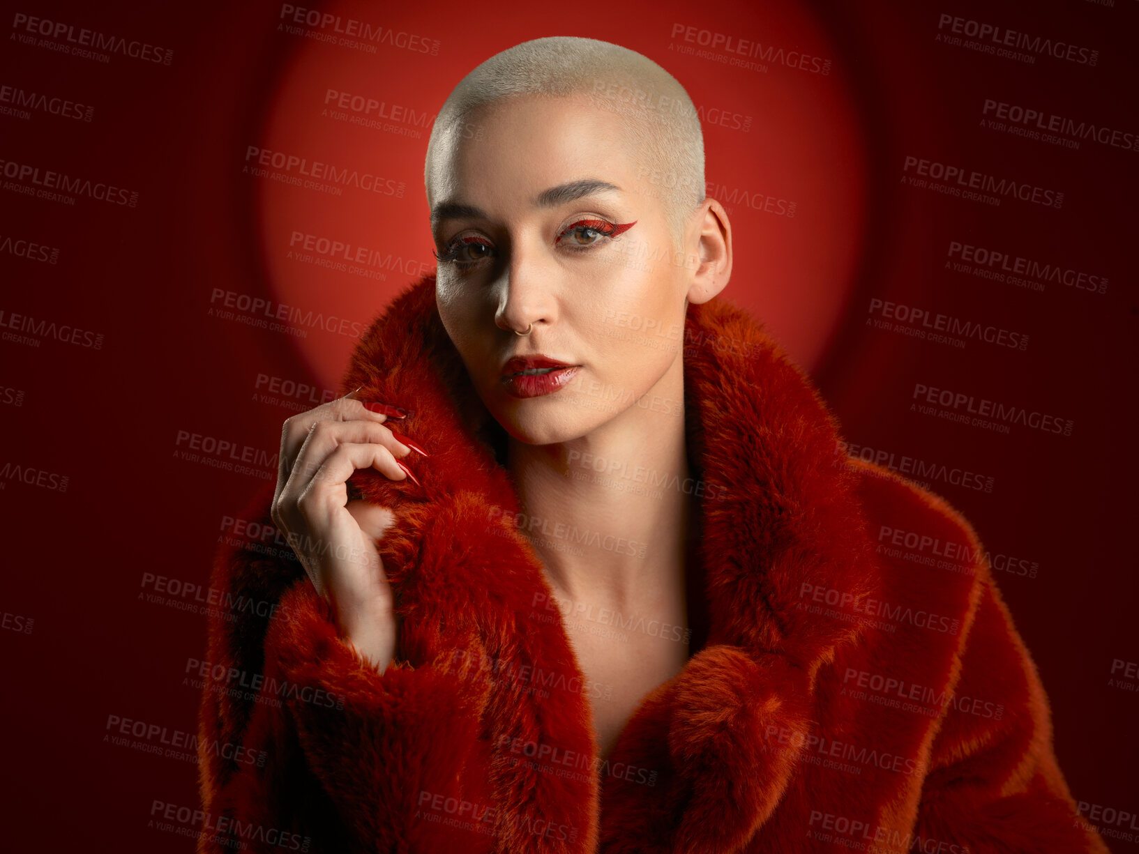 Buy stock photo Fashion, portrait and confident woman in a red coat in studio isolated on a background. Face, makeup and serious model with cosmetics, aesthetic and style, trendy and fur clothes from Switzerland.