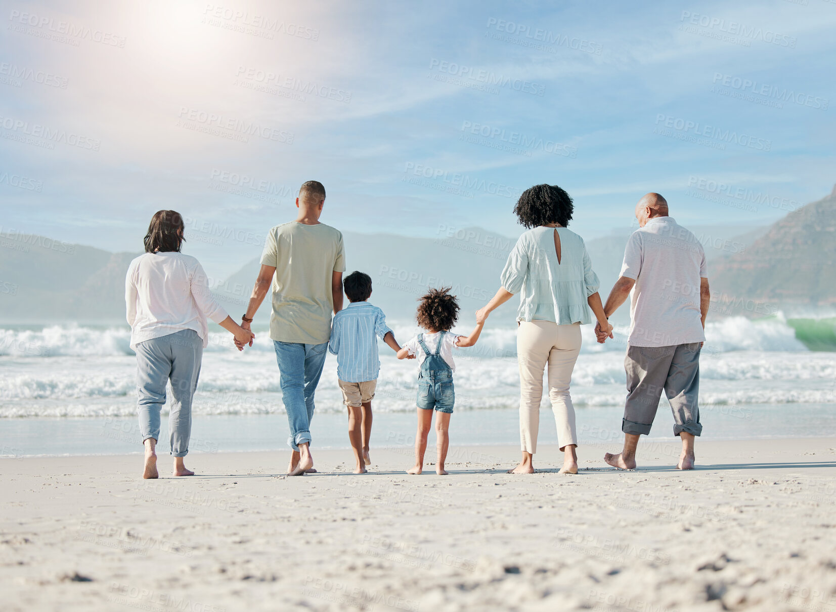 Buy stock photo Back, beach and family holding hands, walking and summer vacation with bonding, love and travel. People, grandparents and mother with father, children and kids with seaside holiday, ocean and care