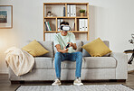 Virtual reality glasses, relax and man with game, controller and connection with software, smile or internet. Person, gamer or guy on a sofa, VR eyewear or geek with online playing, home or metaverse