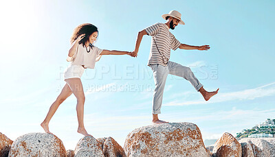 Buy stock photo Beach, rocks and couple with vacation. walking and travel with happiness, bonding together and carefree. Seaside, fun and man with woman, adventure and journey with weekend break and summer holiday