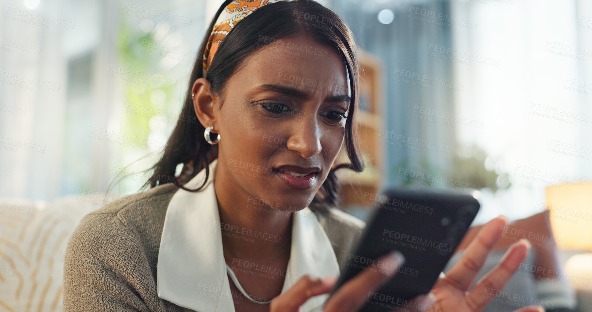 Buy stock photo Indian woman, home and stress on smartphone in sofa on website with fake news and online scam. Female person, gen z and frustrated or worried with cybercrime,  internet fraud and spam in living room