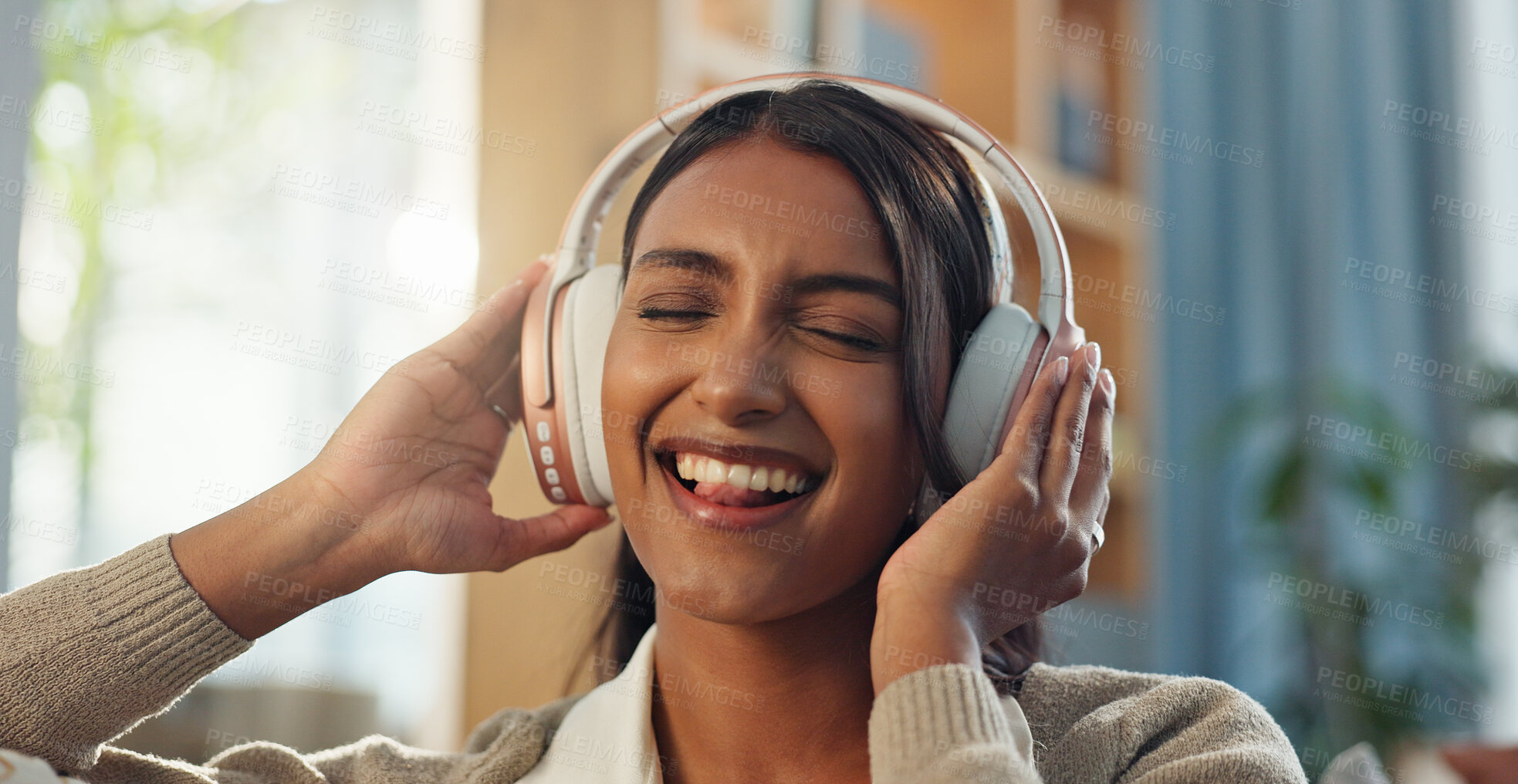 Buy stock photo Woman, face and happy with music headphones in home for streaming playlist, kpop artist and hearing sound. Girl smile, tech and listening to edm audio for favorite song, podcast and online radio