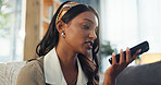 Cellphone, talking and indian woman in home, sofa and communication on speaker in lounge. Gossip, conversation and internet for networking online, female person and mobile discussion on phone call