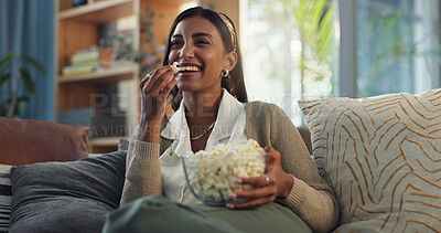 Buy stock photo Happy, girl and relax on sofa with popcorn for watching movies, streaming comedy film and unwind on weekend for break. Woman, laughing and snack in home for online subscription and entertainment.