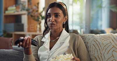 Buy stock photo Indian woman, home and watching television with popcorn on streaming platform for movies or series. Female person, tv remote and smile or happy with snack for subscription, fun and enjoy on sofa