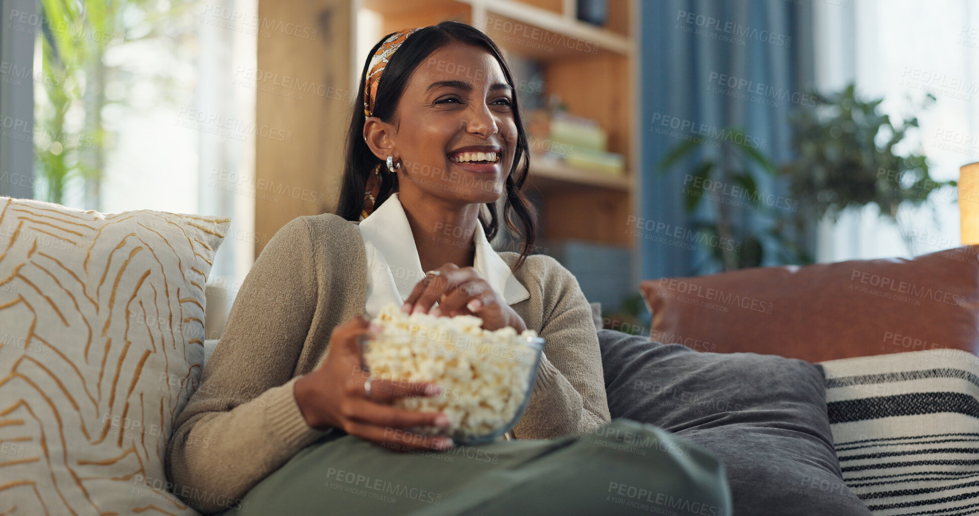 Buy stock photo Smile, girl and relax on sofa with popcorn for watching movies, streaming comedy film and unwind on weekend for break. Woman, laughing and snack in home for online subscription and entertainment.