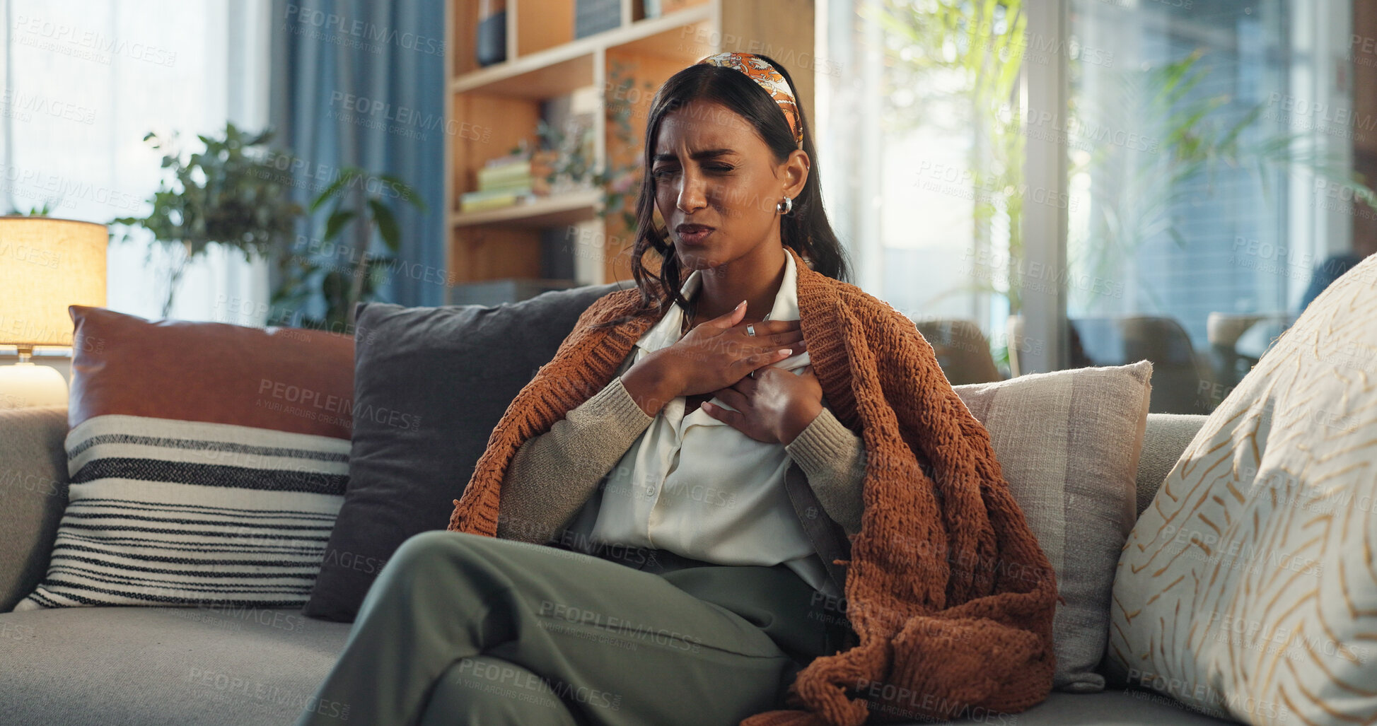 Buy stock photo Sick woman, hands and chest with infection, pain or virus on sofa in living room at home. Girl with illness, cold or flu for sore lungs, disease or acid from thyroid inflammation or respiratory ache